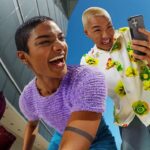 Two people looking at a T-Mobile phone