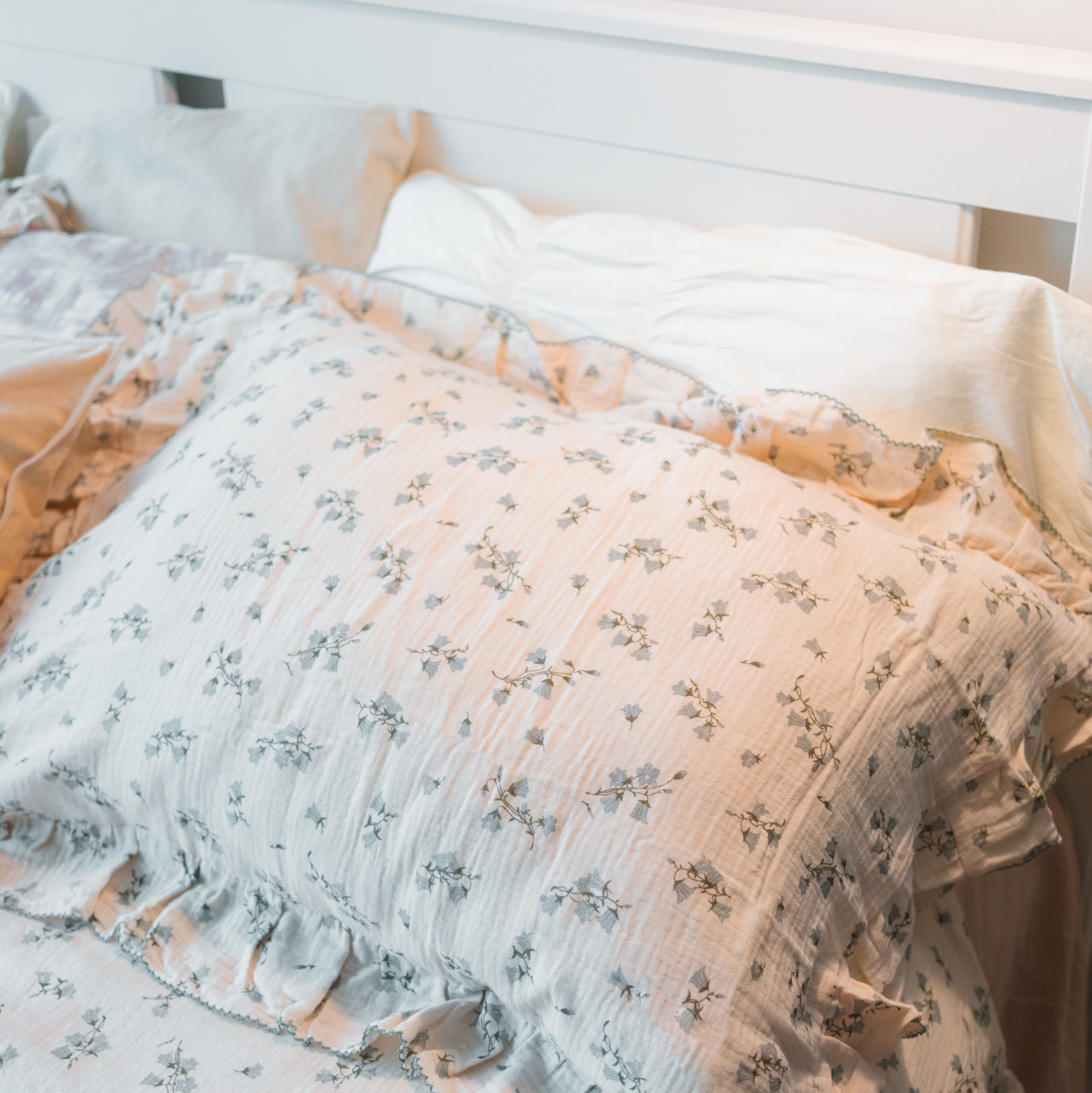 next to the floral pillow and duvet on the double bed in the bedroom