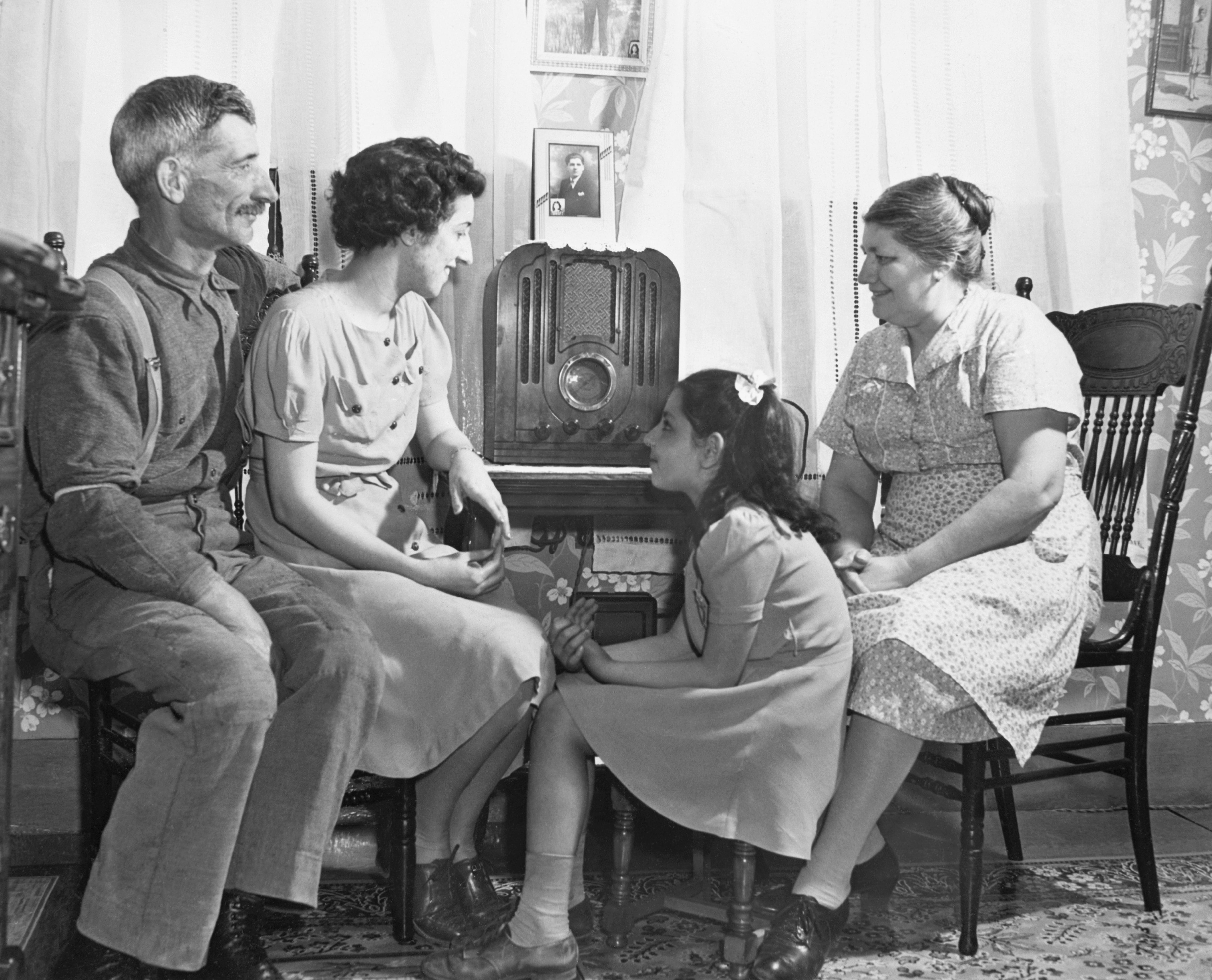 the family gathered around the radio