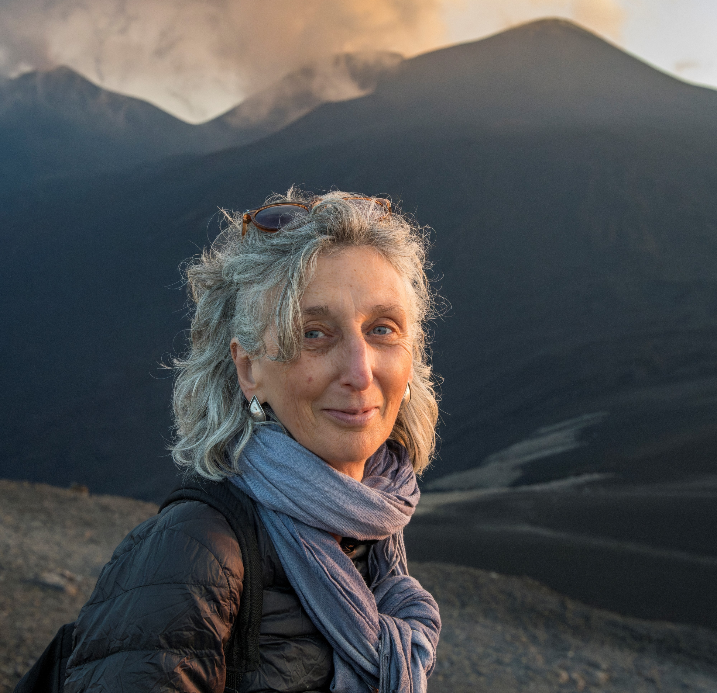Helena Attlee standing with a volcano in the background.