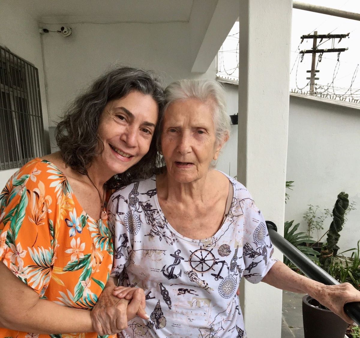 Eliana Ferreira Keen pictured here with her late mother Elza Ferreira. The women are wearing colorful dresses