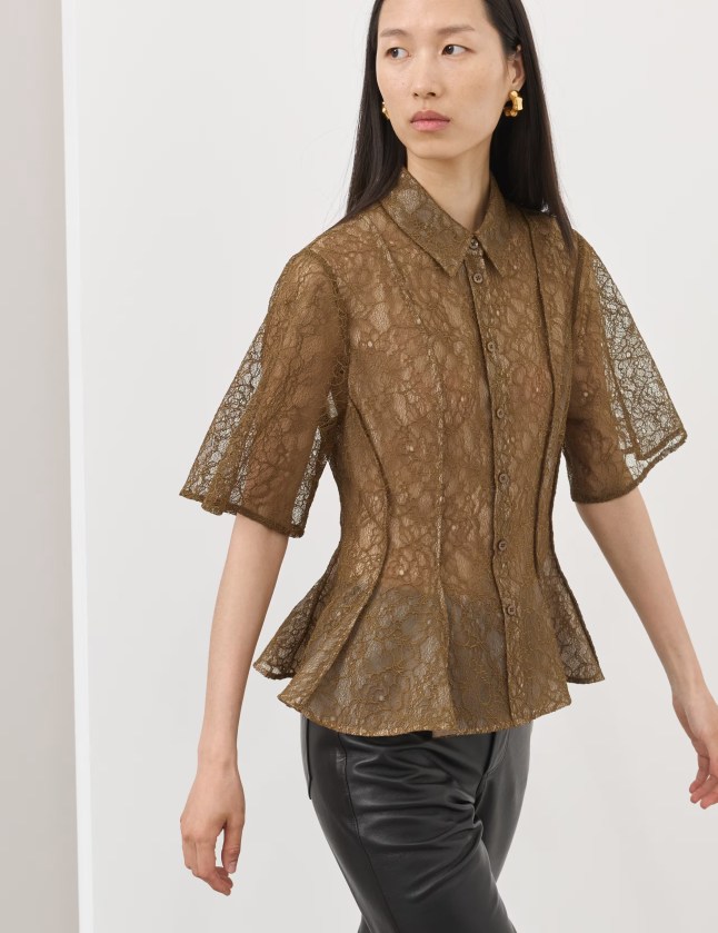 The female wears a dark colored lace top