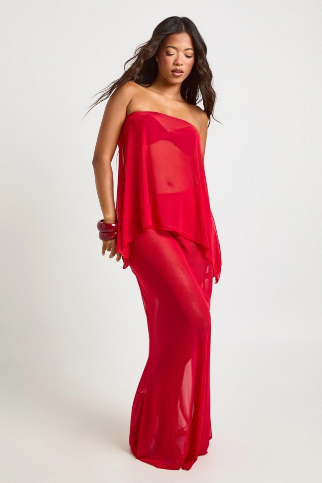 The woman is wearing a red lace dress