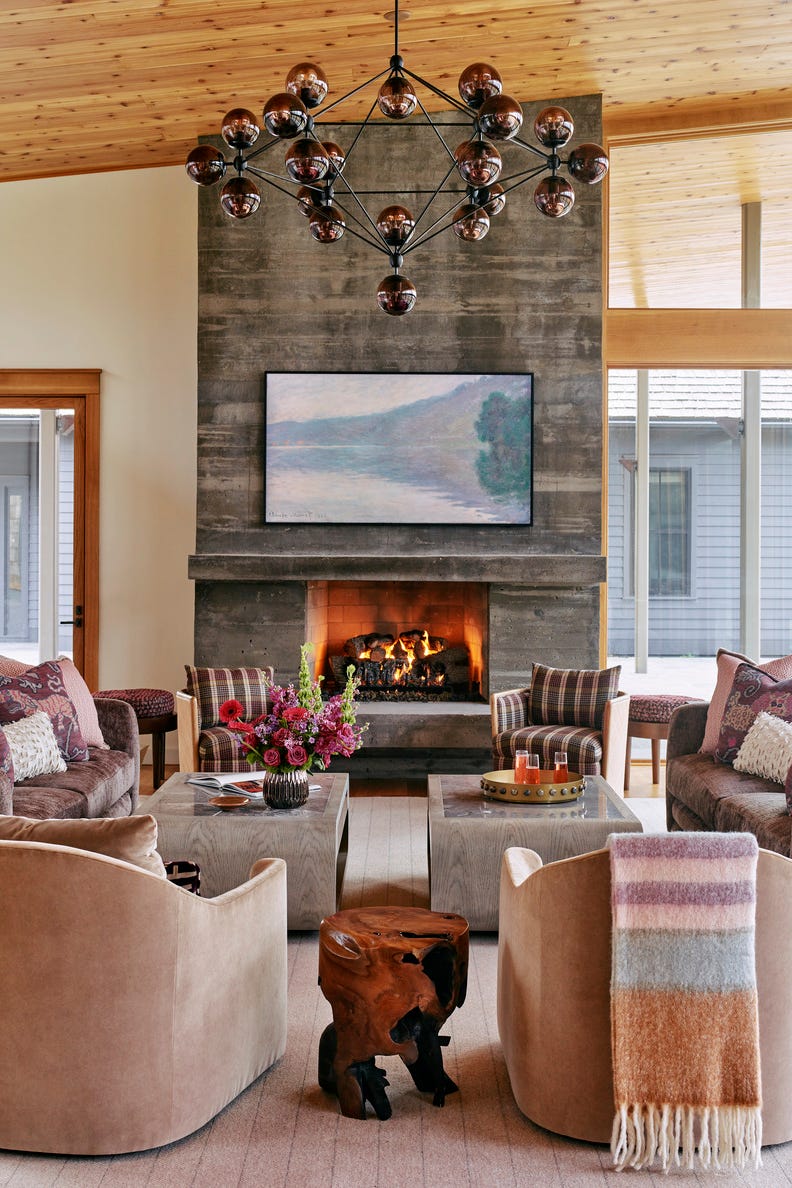 living room: a concrete fireplace with a board pattern to create a subtle, warm wood grain effect. lighting: bunny williams home. tables: highland furniture. chandelier/ The act of wearing: on a hill. roaring creek, north carolina vacation home designed by liz carroll interiors. resident architect Clark dad. colorful design. living room: a concrete fireplace with a board pattern to create a subtle, warm wood grain effect. lighting: bunny williams home. tables: highland furniture. chandelier/ The act of wearing: on a hill. roaring creek, north carolina vacation home designed by liz carroll interiors. resident architect Clark dad. colorful design.
