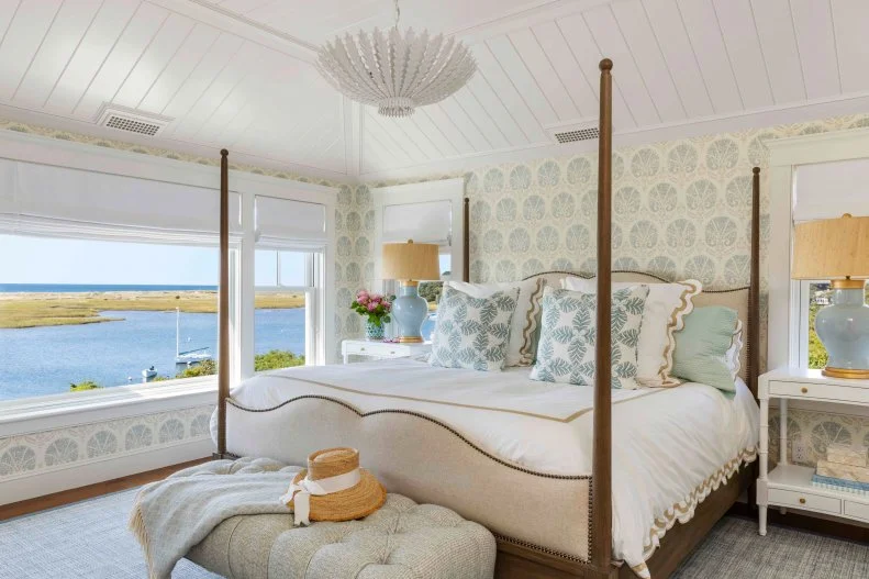 Traditional beach bedroom with coffered ceiling and painted wallpaper White bedroom with vaulted ceiling and four beds.
