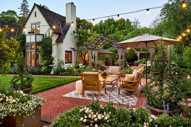 An intimate Residence surrounded by Flowers Tudor house with brick patio