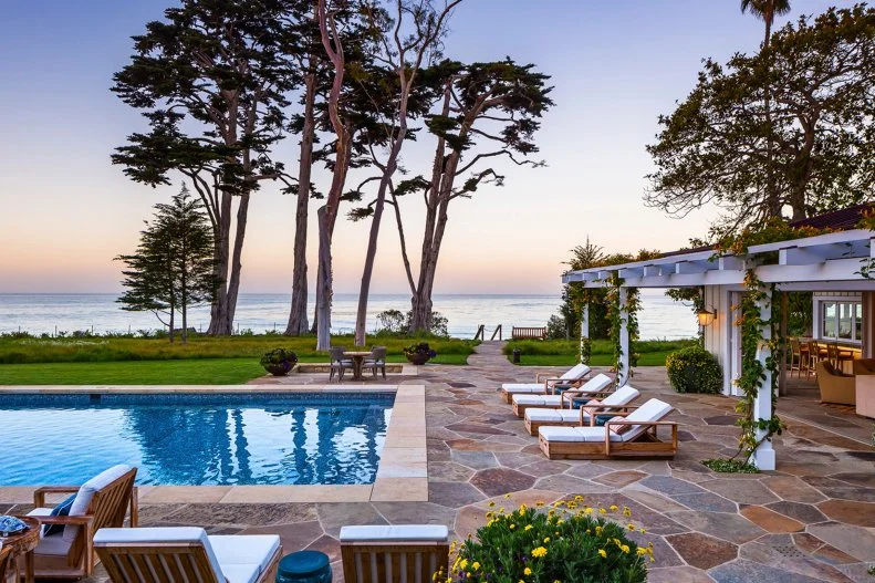Modern Stone Patio With White Cushioned Lounge Chairs And Beach Access Contemporary Pool Patio