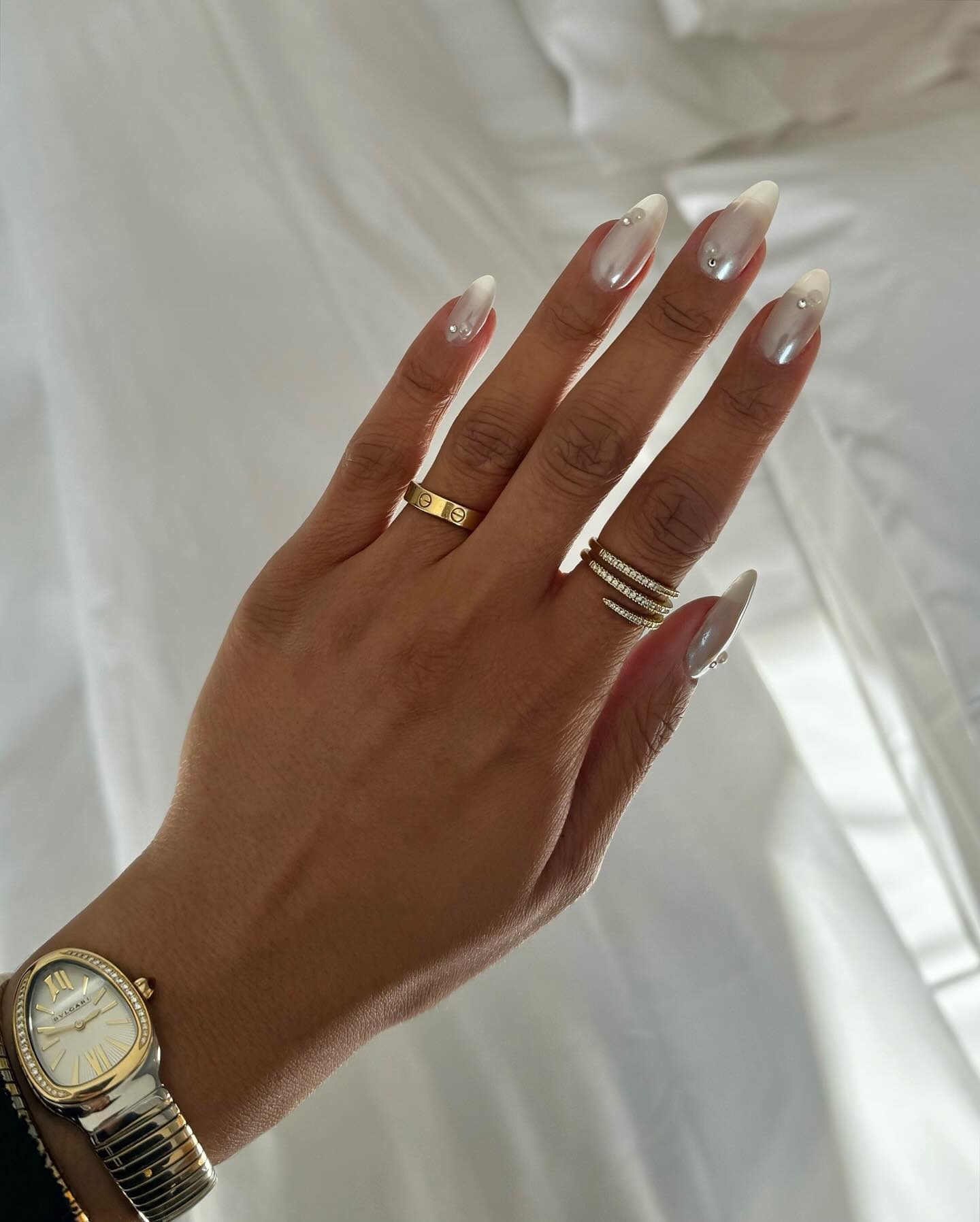 Long, almond-shaped pearl manicure