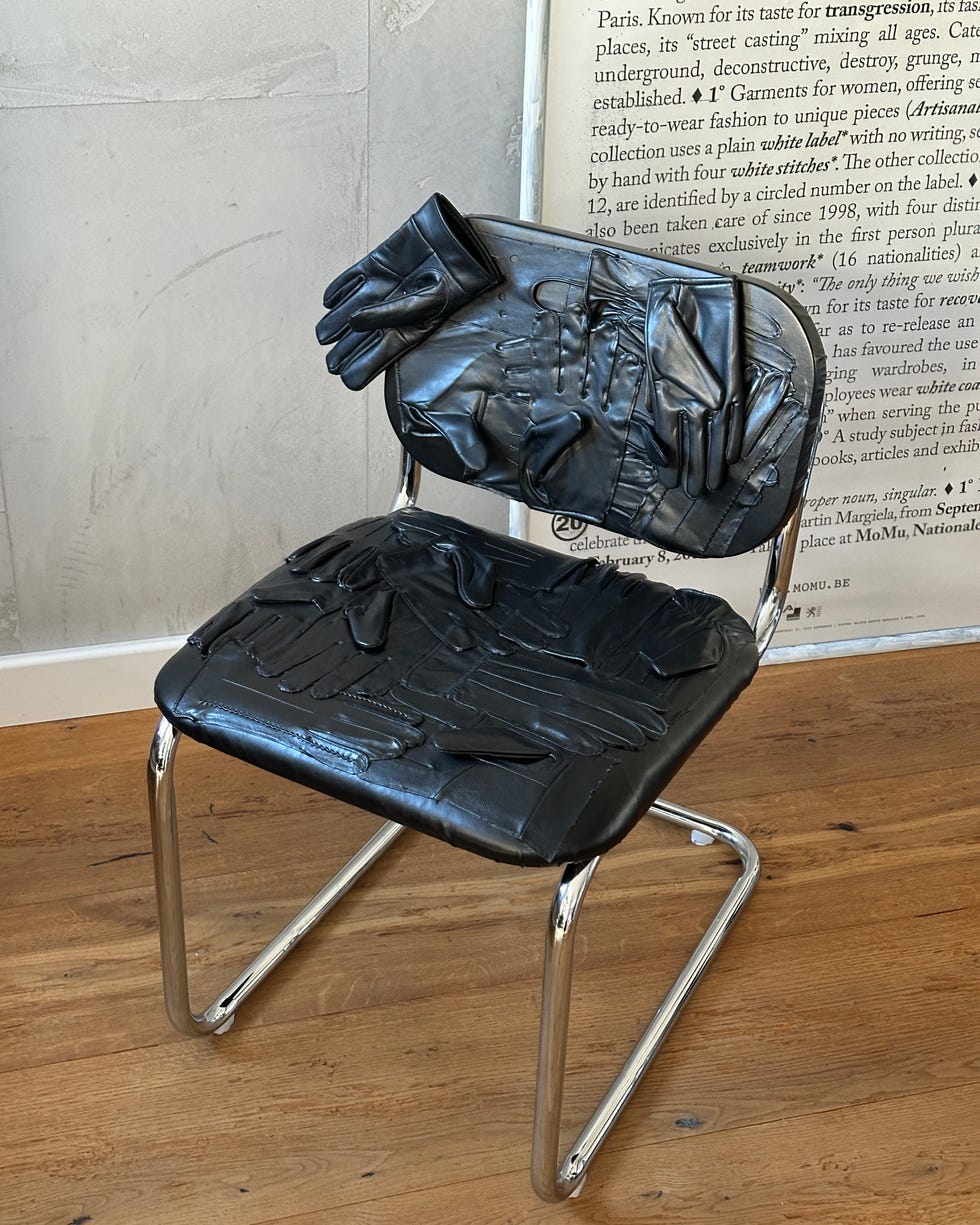 A chair with a surface designed to resemble black gloves.