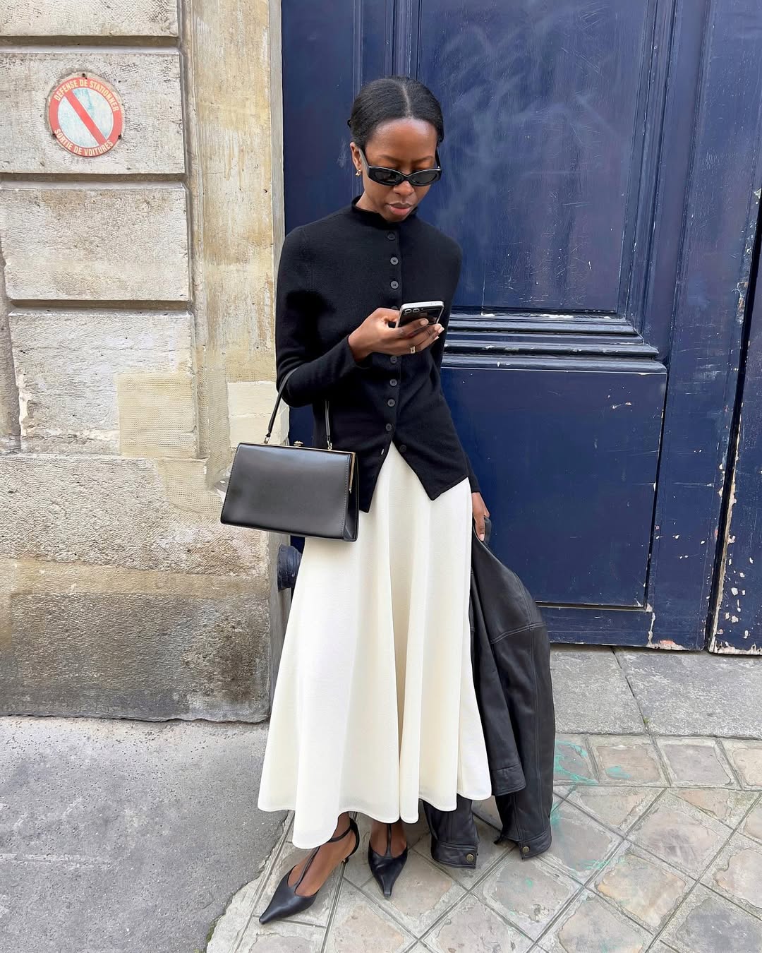 Influencer Sylvie Mus wearing a monochrome dress and cardigan.