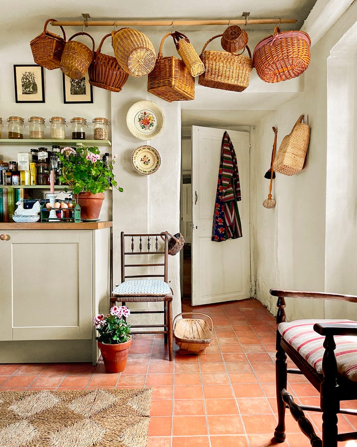 Kitchen with basket collection, tile floor, open shelves, white cabinets
