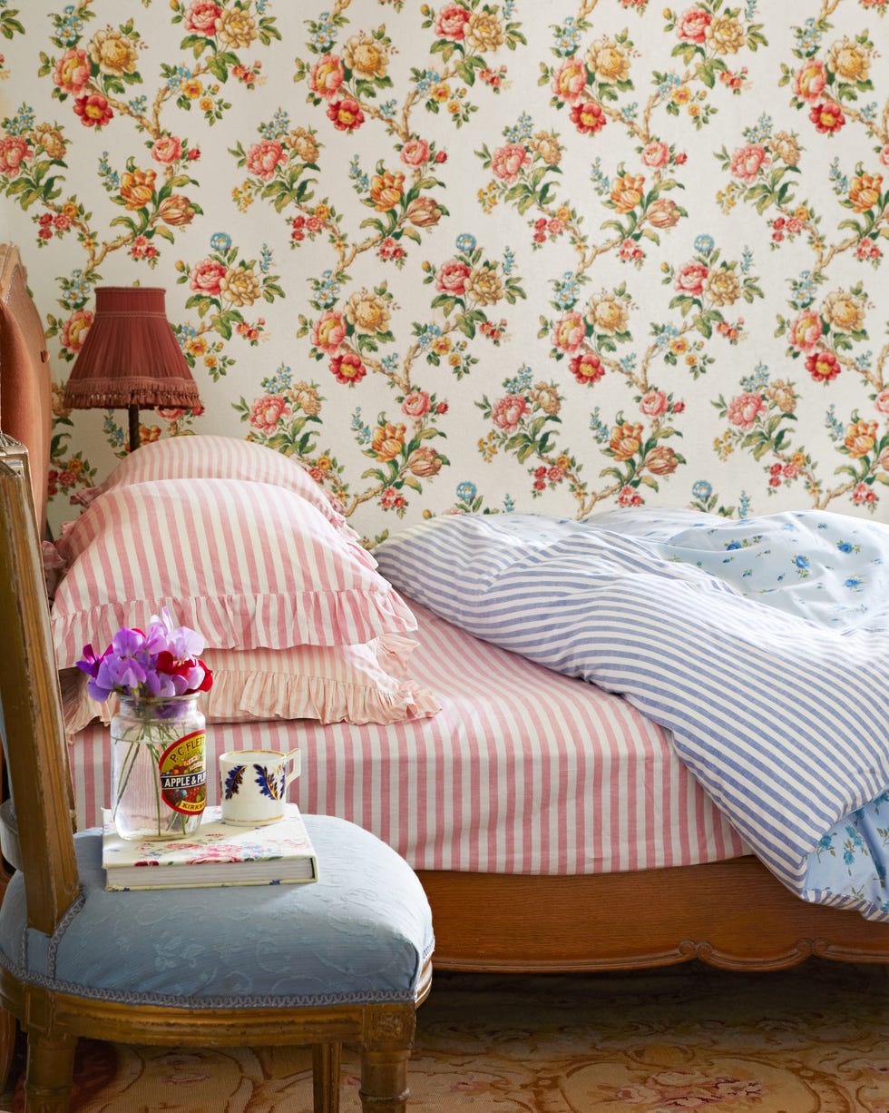 bedroom with floral wallpaper and pink bedding