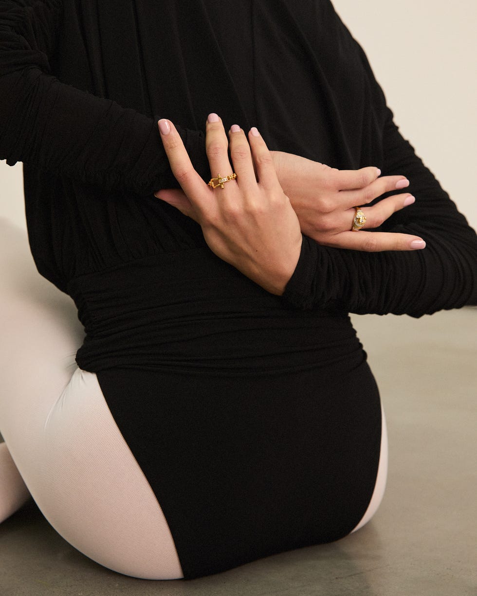 a person who shows beauty by focusing on hands and dress