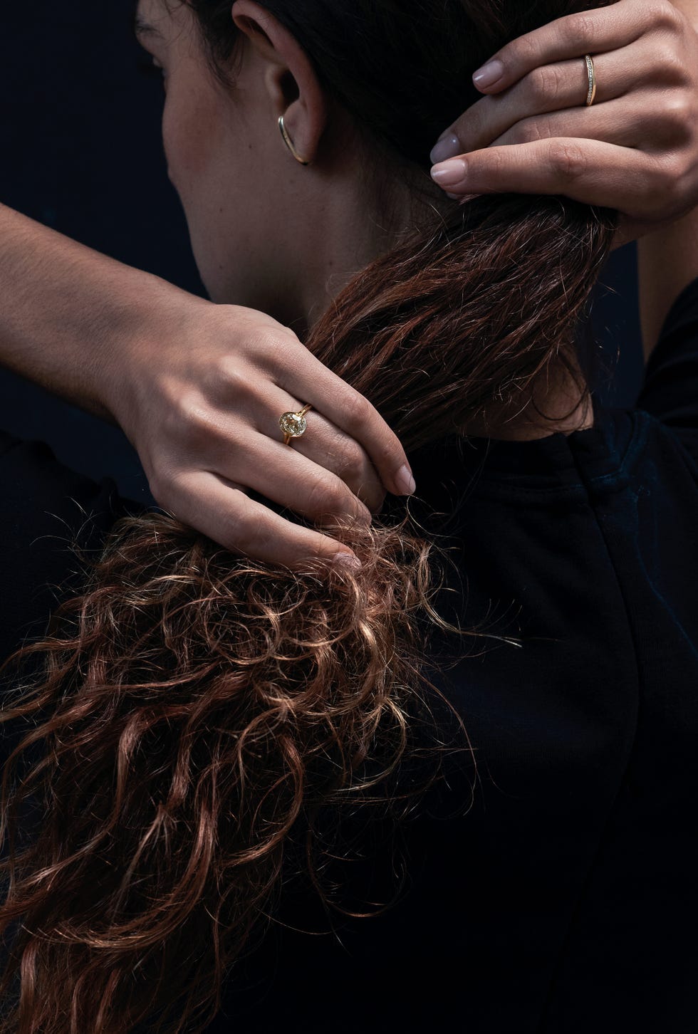 stylish hands long curly hair showing jewelry