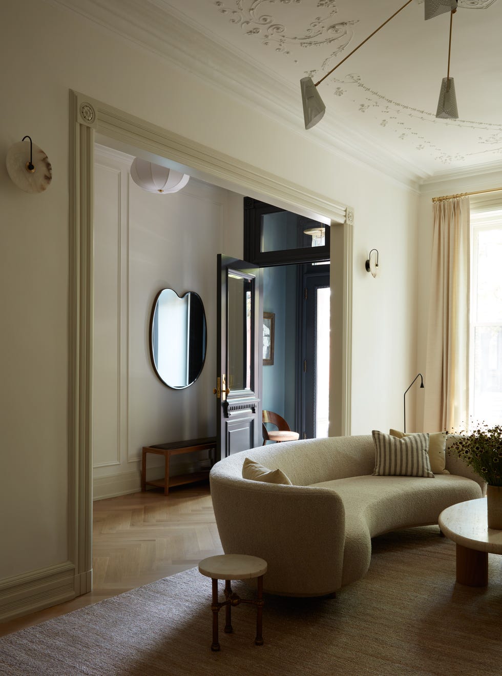 modern living room with curved sofa and natural light