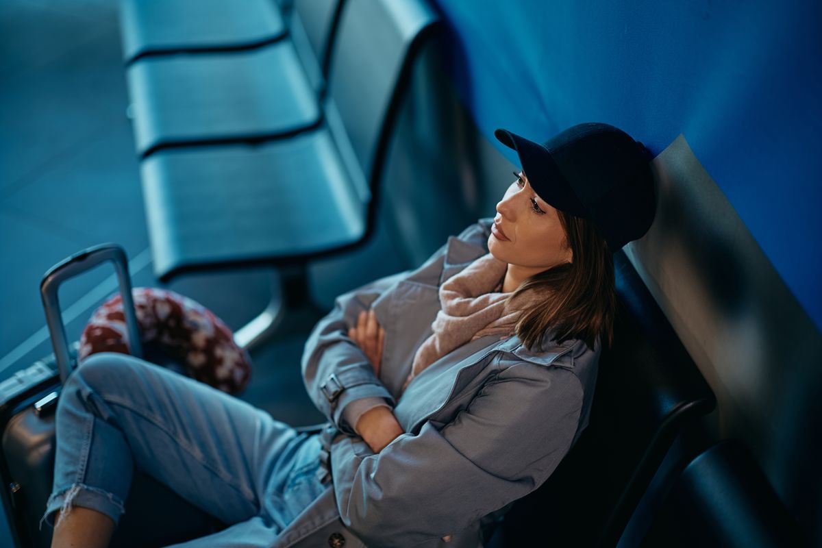 A woman waiting in the airport departure area