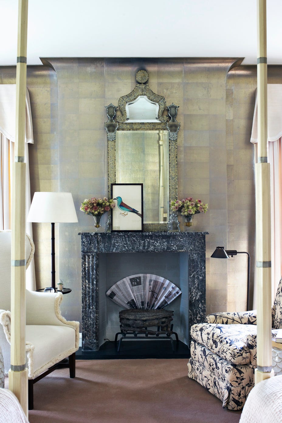 An interior room with an ornate fireplace and an ornate mirror An interior room with an ornate fireplace and an ornate mirror