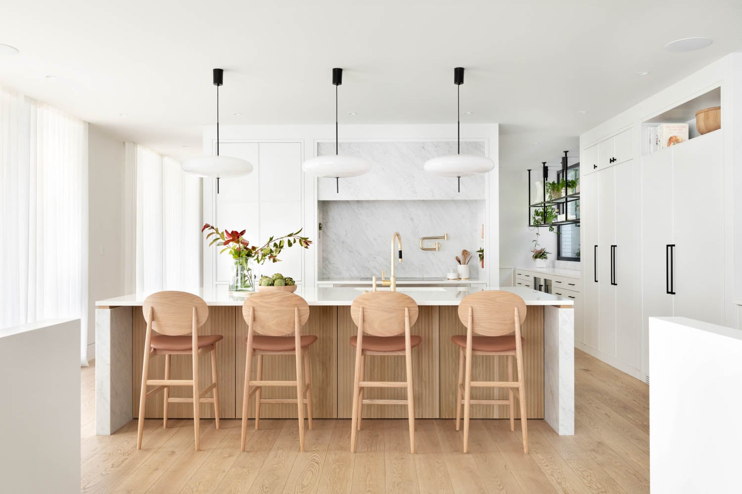 In the kitchen, the Outline counter stools by Norm Architects are from Hem Interiors and the Model 2065 pendants are from Astep.