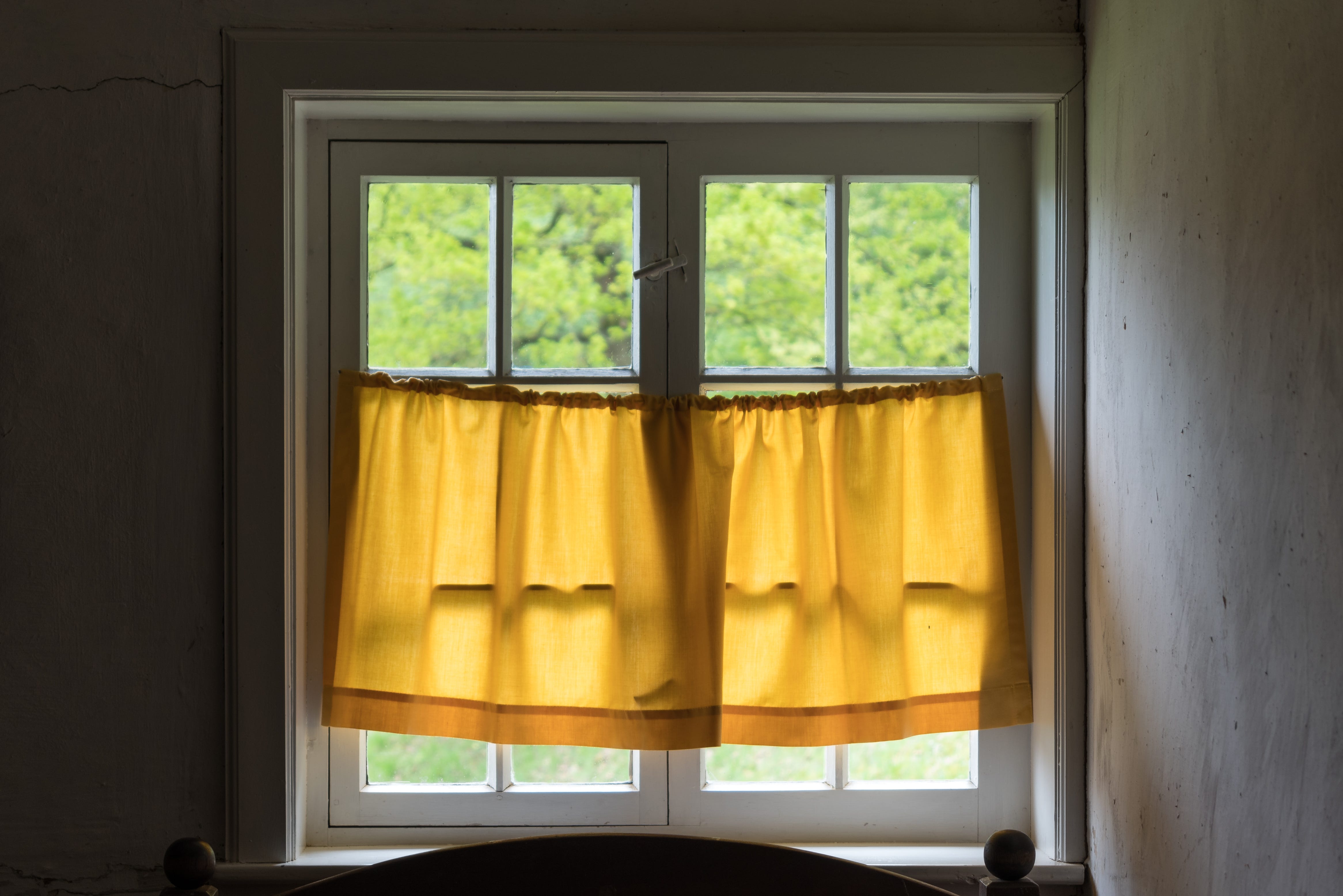 a shuttered window of an old farmhouse inside