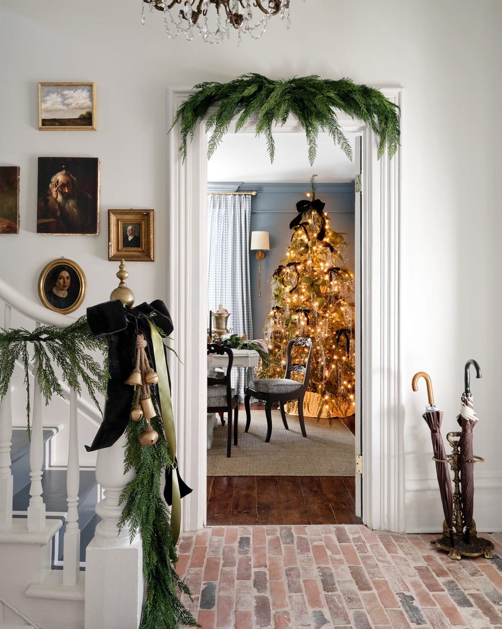 entering a blue-painted dining room with a dining table and covered tree