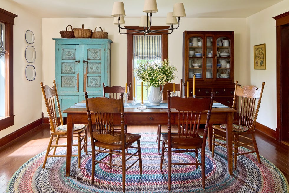 dining room with wooden table and chairs along with antique cabinets